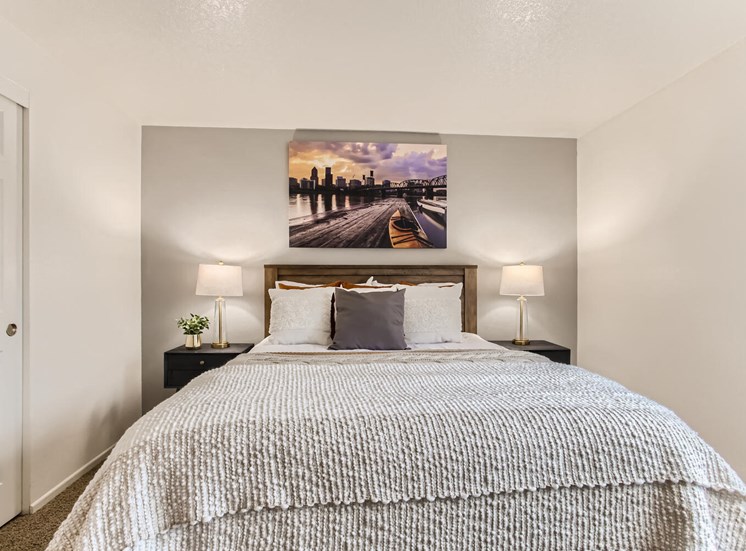 One-Bedroom Apartments in Lake Oswego, OR - Westlake Meadows - Bedroom with Double Nightstands, Wall Art, and Grey Accent Wall